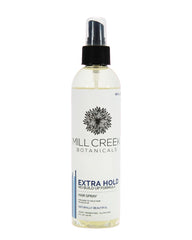 Spray natural para cabello Mill Creek primer plano de la botella con fijación duradera.