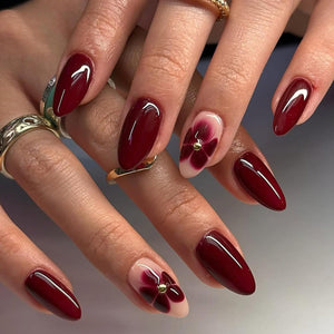 ASABITE uñas almendra rojas con diseño floral, perfectas para ocasiones especiales.