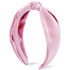 Atoden banda rosa con nudo superior, primer plano, ideal para estilizar peinados diarios.