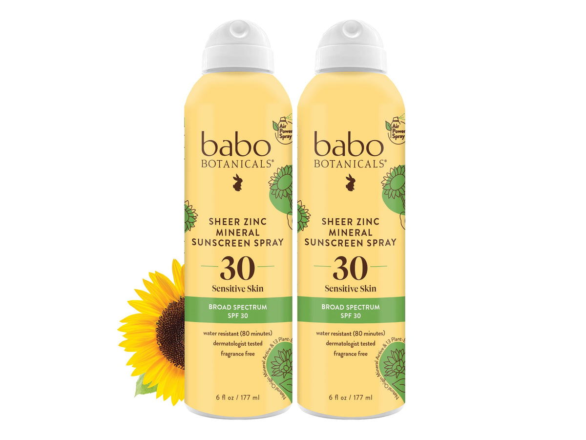 Babo Botanicals spray zinc-transparente en botella para piel sensible en uso diario.