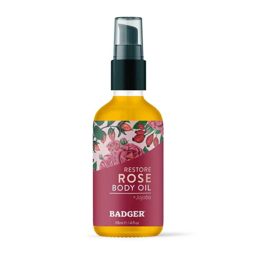 Badger Aceite corporal de rosa en botella de vidrio para hidratación suave.