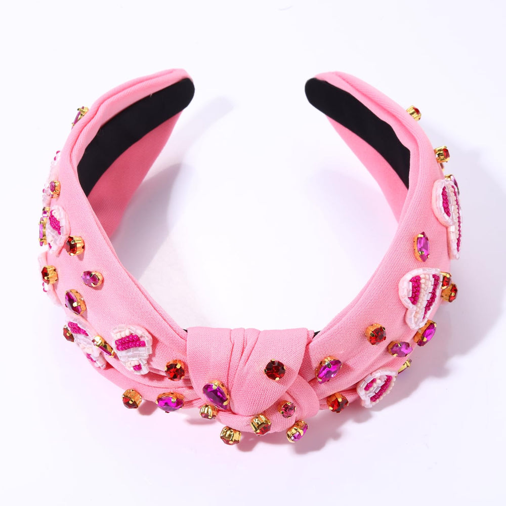 Diadema boderier de terciopelo rosa con detalle delicado.