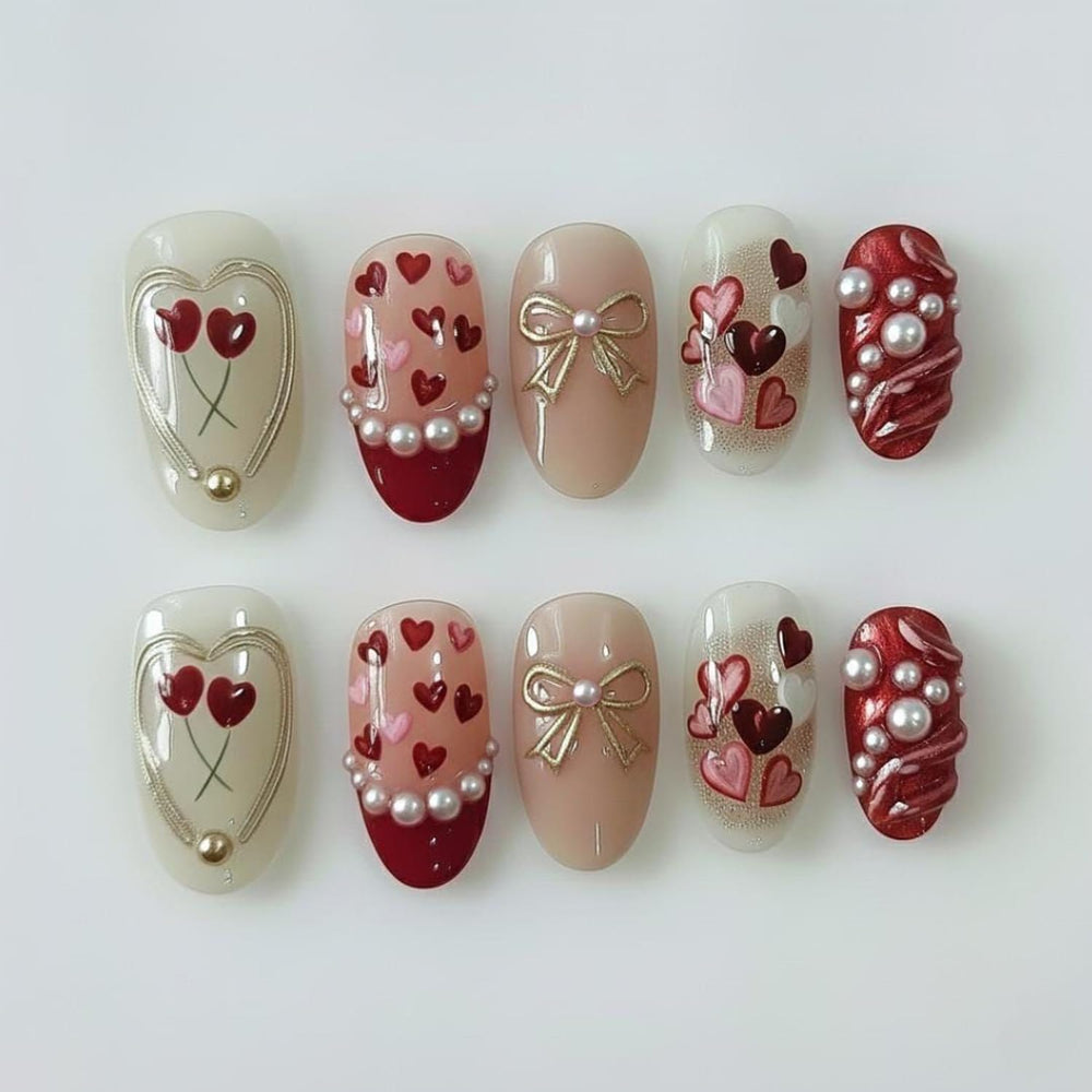 BSBTBZ uñas San Valentín con corazones rojos y perlas, ideales para eventos románticos.