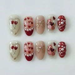 BSBTBZ uñas San Valentín con corazones rojos y perlas, ideales para eventos románticos.