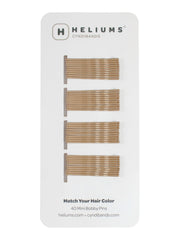 Heliums mini horquillas rubio oscuro en empaque práctico, ideal para organizar tu neceser