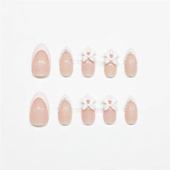 LRKNNO uñas almendra con tip francés y lazo decorativo para look pulido.