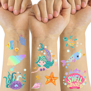 Tatuajes Metuu de sirenas para niños con brillo dorado, ideal para fiestas.