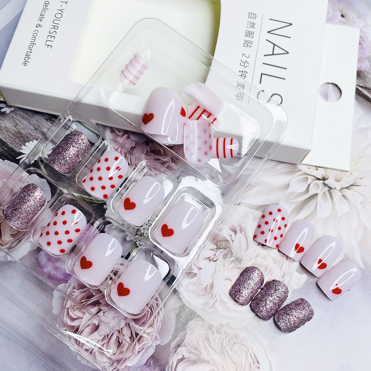 Diseño corazón brillante NEWSPIED en uñas rosas para looks elegantes