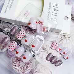 Diseño corazón brillante NEWSPIED en uñas rosas para looks elegantes