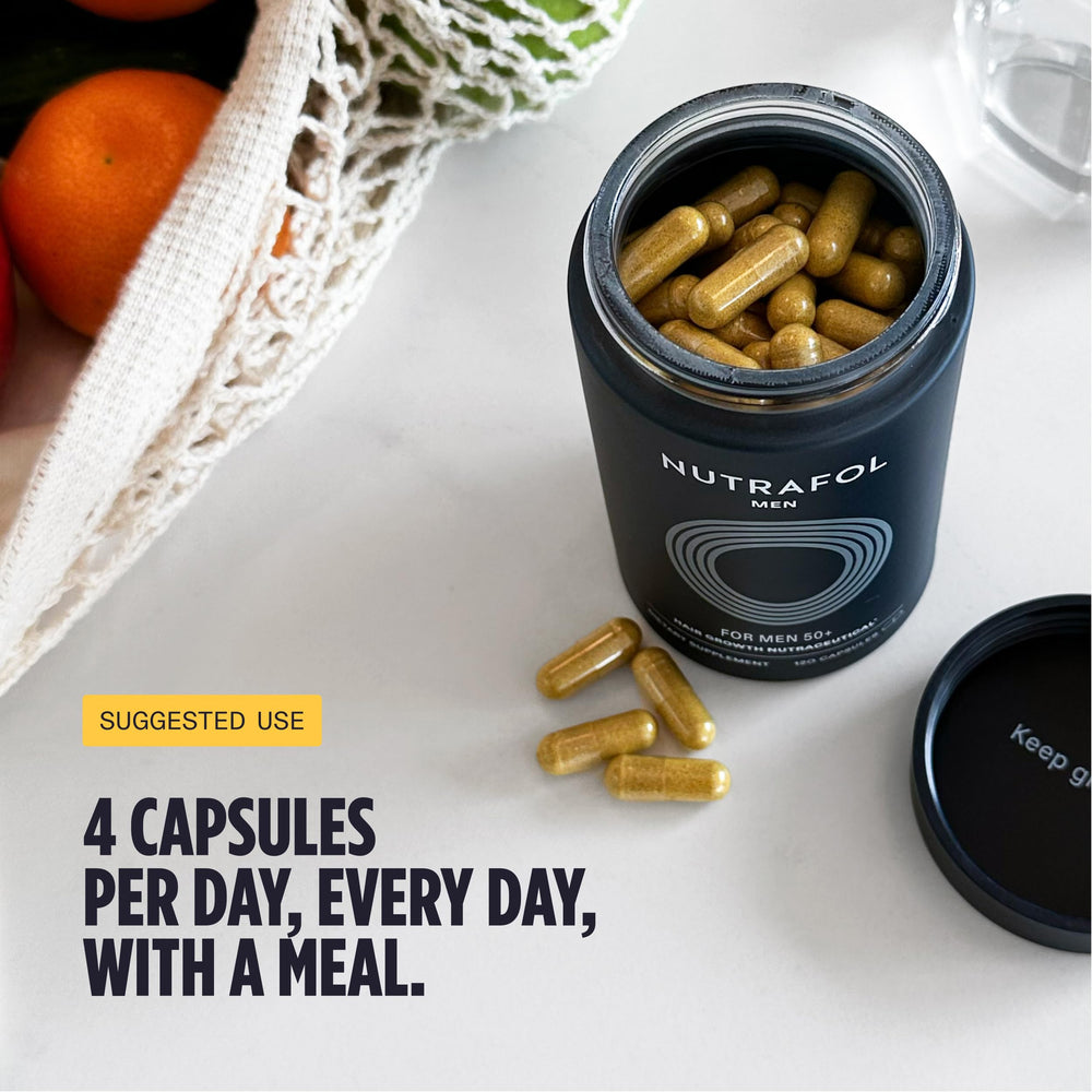 Nutrafol Men 50+ bottle beside glass of water encourages 4-capsule daily dose.