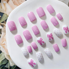 PowPop uñas rosa corto con lazo para uñas naturales.
