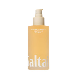 Saltair Body Oil bottle pour showing luxurious salt water vanilla fragrance and quick absorption.