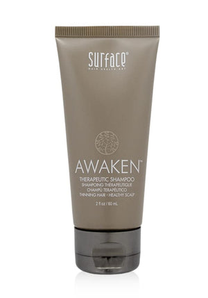 Surface Champú Despertar: botella mostrando fórmula natural para cabello más saludable.