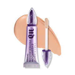 URBAN DECAY Eyeshadow Primer Potion Nude: botella translúcida para párpados lisos y colores duraderos.