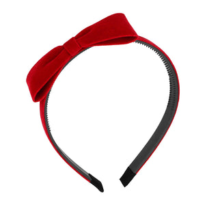 Diadema Yariew con nudo rojo en terciopelo, ideal para looks audaces.